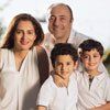 A family of four posing for a picture together.