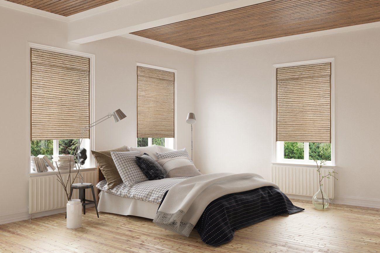Bedroom with bed, three windows with blinds, and wooden ceiling.