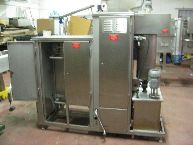 Stainless steel industrial machine, cabinet doors open.