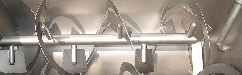 Interior view of a stainless steel industrial mixer with helical blades.
