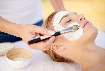 Shot of a young woman getting a facial at a spa