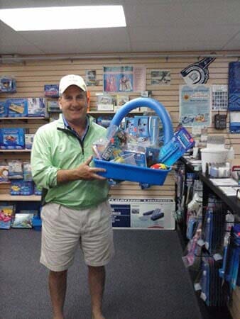 Man holding a Safety Gears for Swimming — Pool Maintenance in Simsbury, CT