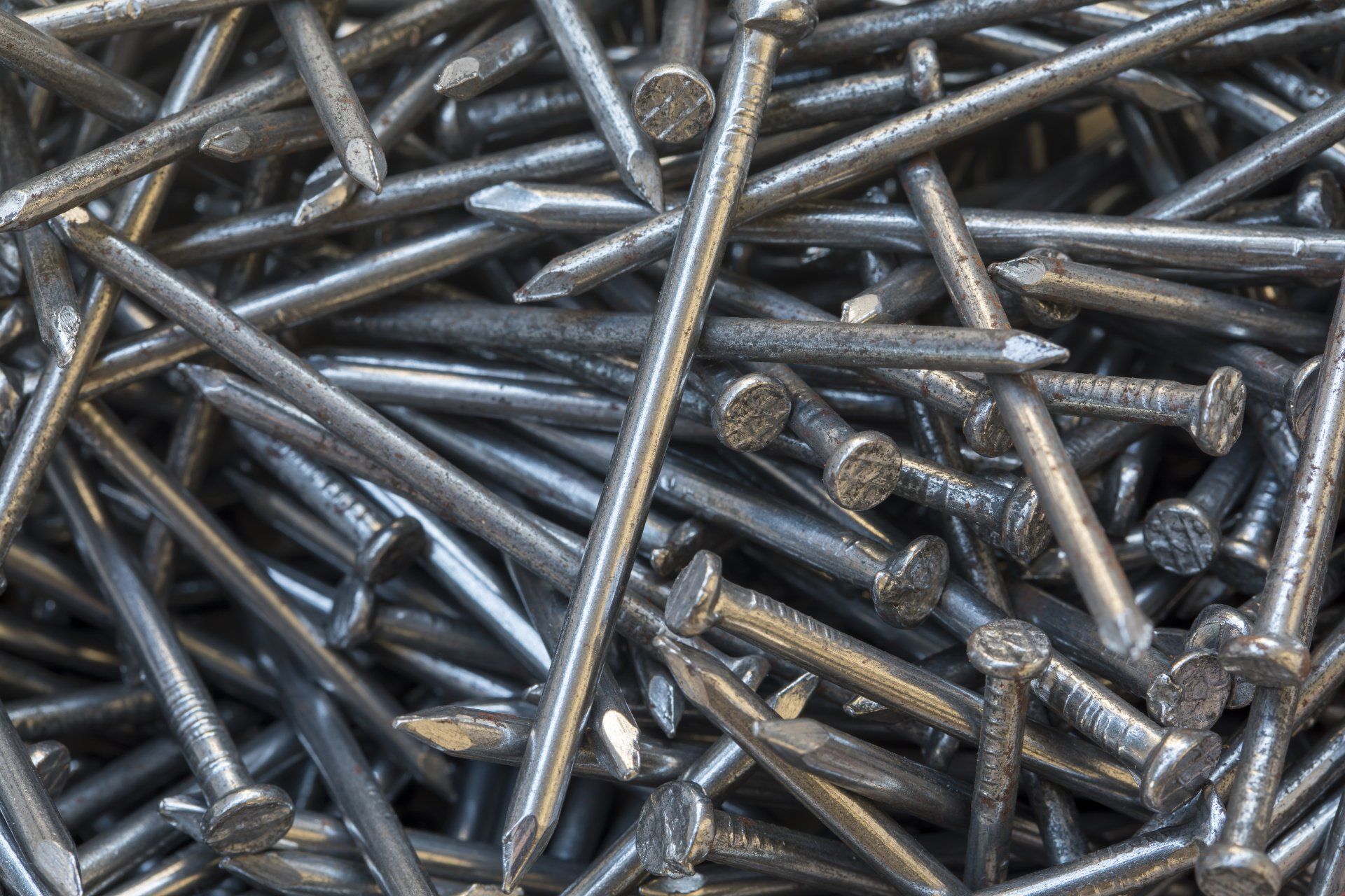 A pile of nails is sitting on top of each other on a table.