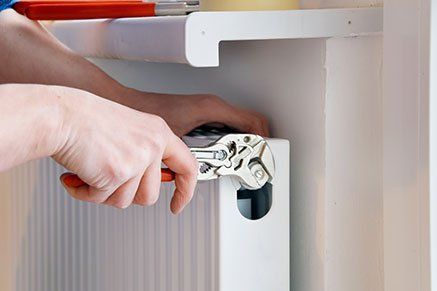 Plumbing Repair Roxboro — Plumber Wrench in Roxboro, NC Plumbing services being performed in Roxboro, NC