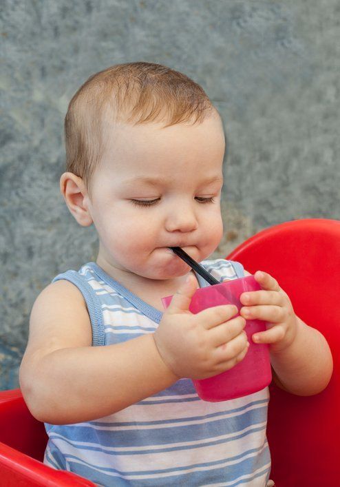 Baby boy drinking with straw