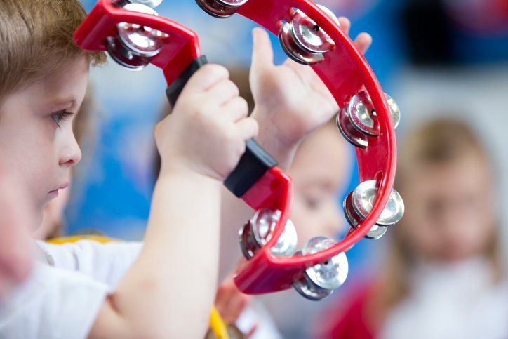Boy playing tambourine
