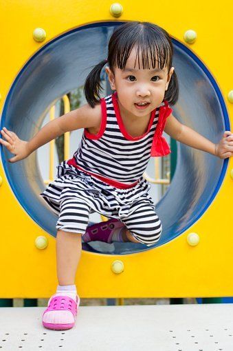Kid Crawling on Playground Tube — Child Care in Victorville, CA