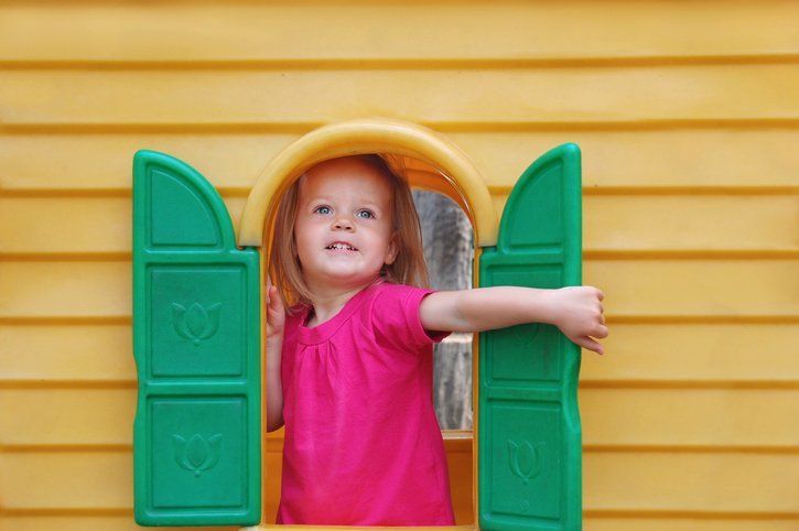 Girl in pink opening green door