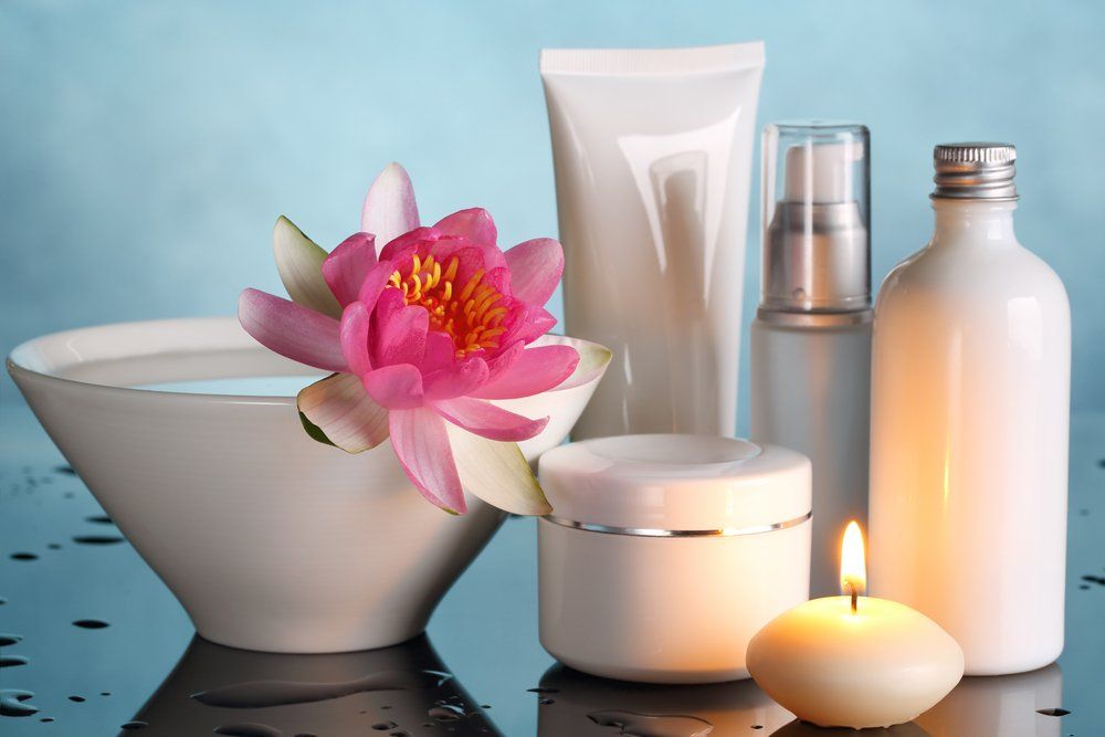 Perfume Bottles With Lotus Flower — VR Mobile Beauty Therapy In Oxenford QLD