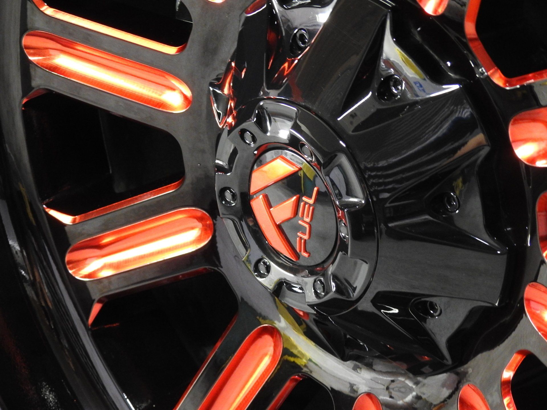 Black and orange Fuel wheel. Shiny black center with orange accents. Fuel logo visible.