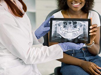 Tablet with Patient X-ray Panoramic Jaw — Palmdale, CA — Posada Dental Practice Tablet with Patient X-ray Panoramic Jaw — Palmdale, CA — Posada Dental Practice