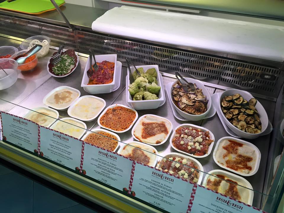 Glass counter with fresh pasta dishes and side dishes