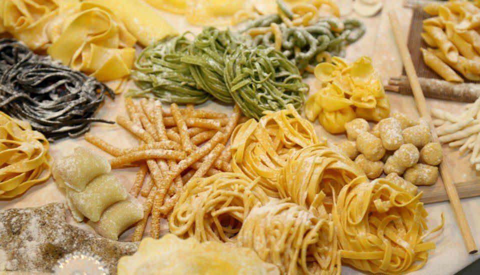 Handmade fresh pasta varieties such as spaghetti and tagliatelle