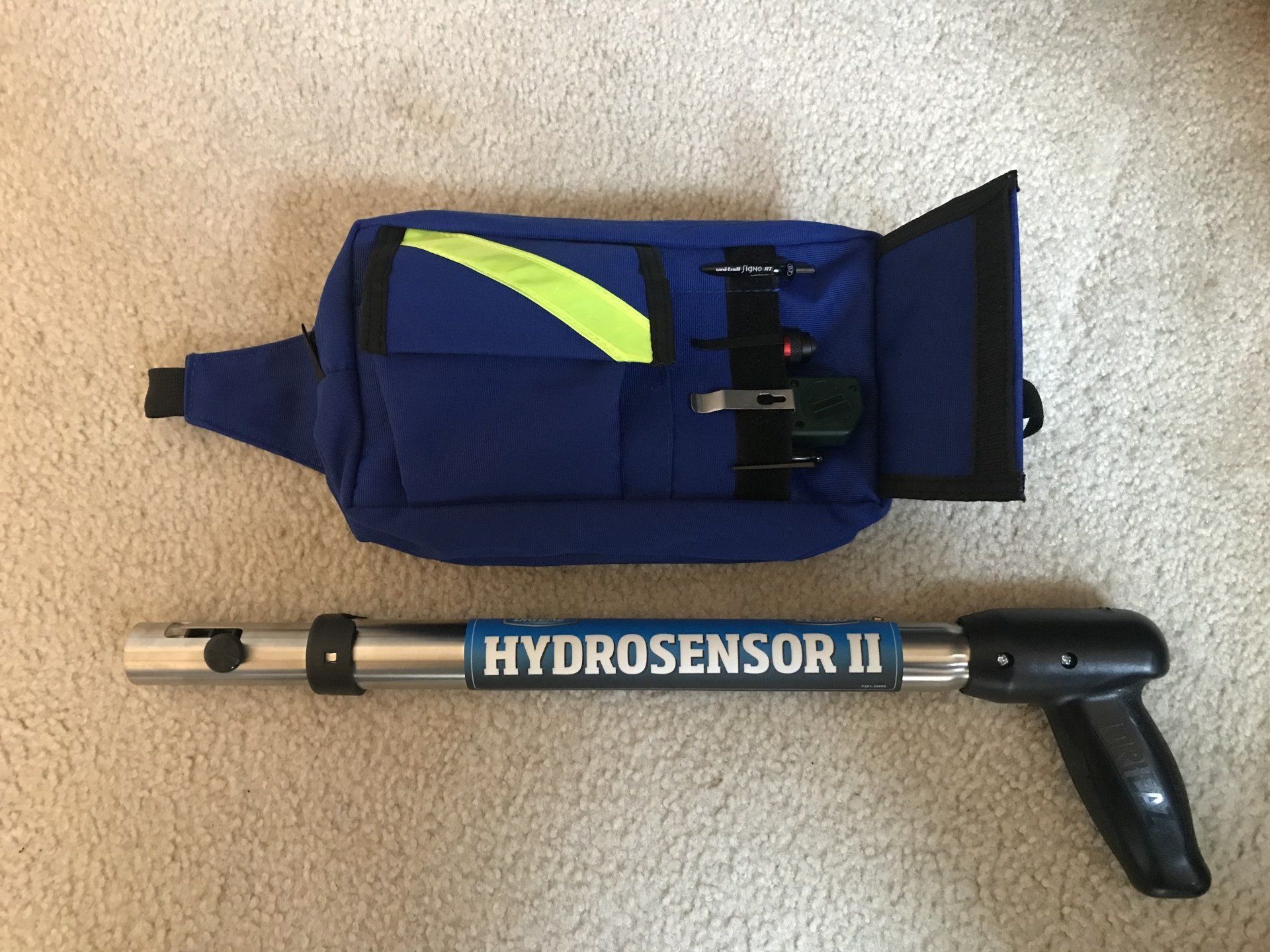 A hydrosensor ii is sitting next to a blue bag