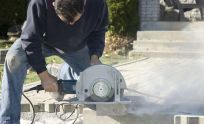 Construction worker with a concrete saw