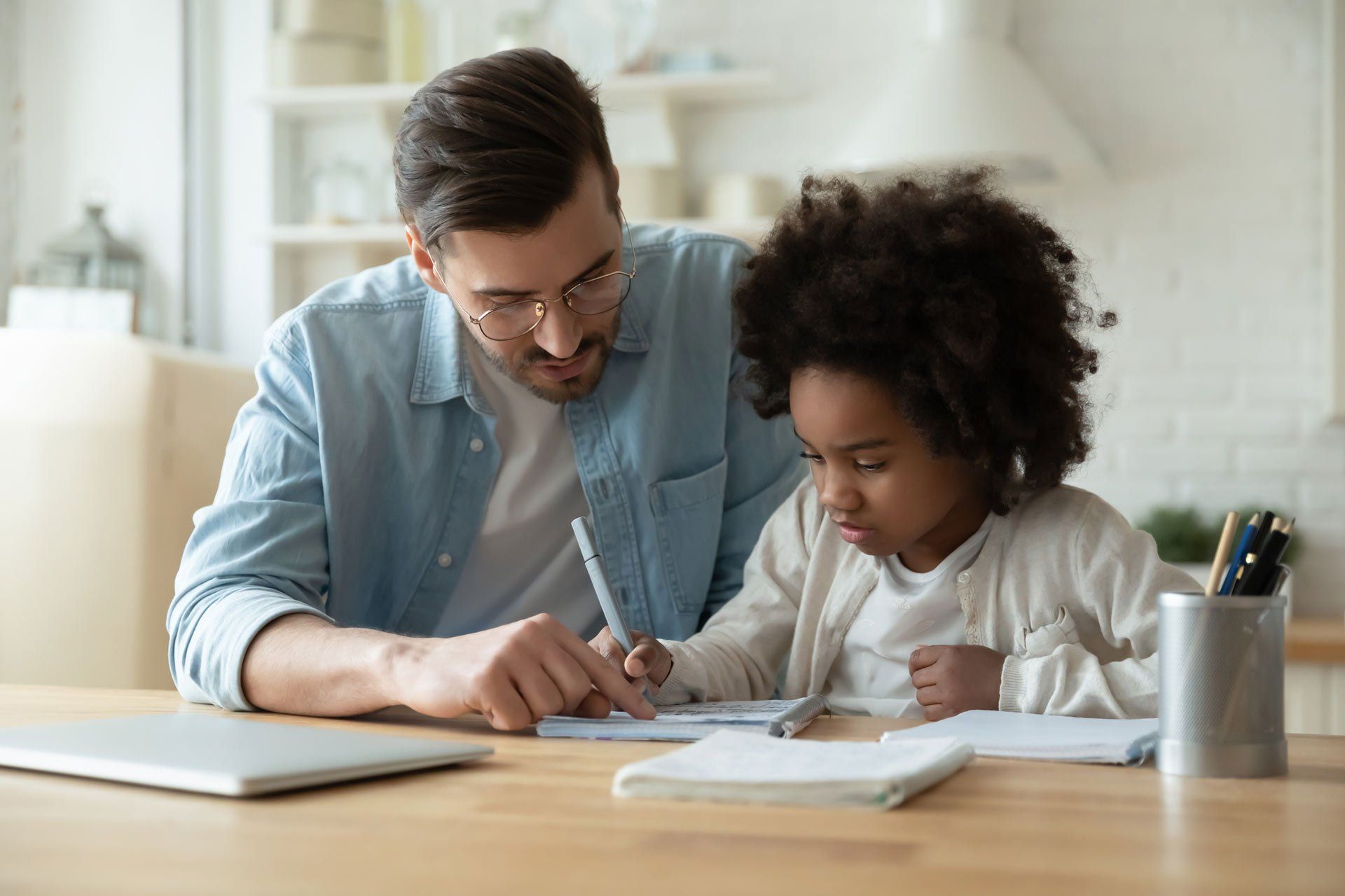 Little Girl Doing Assignment with Her Dad — Miami, FL — Meagan’s Academic Tutorial Center