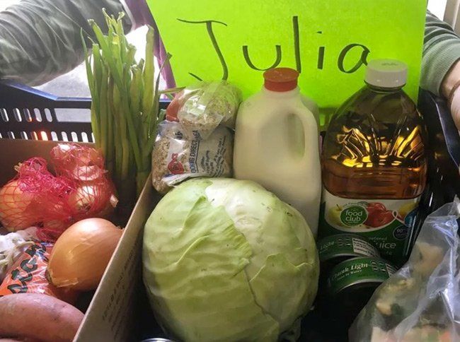 A box of vegetables with a sign that says julia