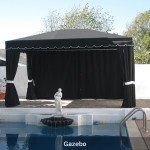 Backyard gazebo with black curtains beside a swimming pool and lounge chairs