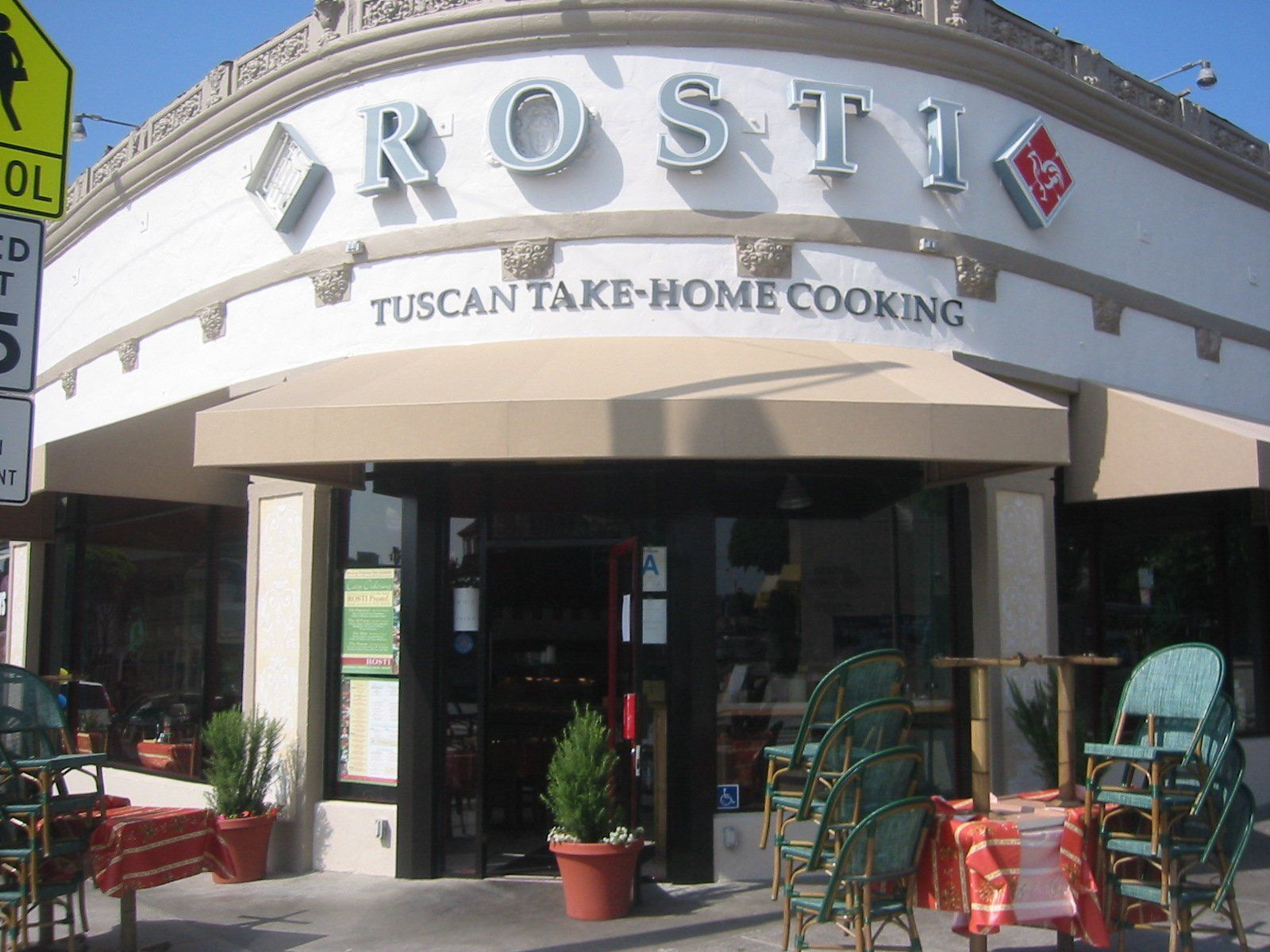 Restaurant storefront with arched sign reading “Rosti” and “Tuscan take-home cooking”