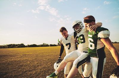 American Football Players Carrying An Injured Teammate — Moulton, AL — Plaxco Chiropractic Clinic American Football Players Carrying An Injured Teammate — Moulton, AL — Plaxco Chiropractic Clinic