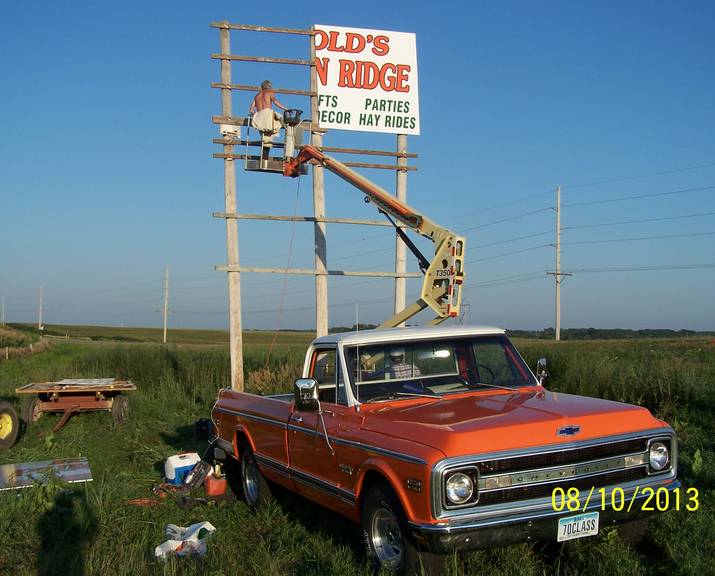 Man creating sign halfway - custom wood, aluminum & lighted signs in Council Bluffs, IA