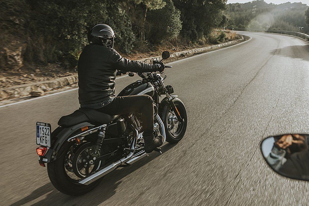 driving next to a motorcyclist around a bend