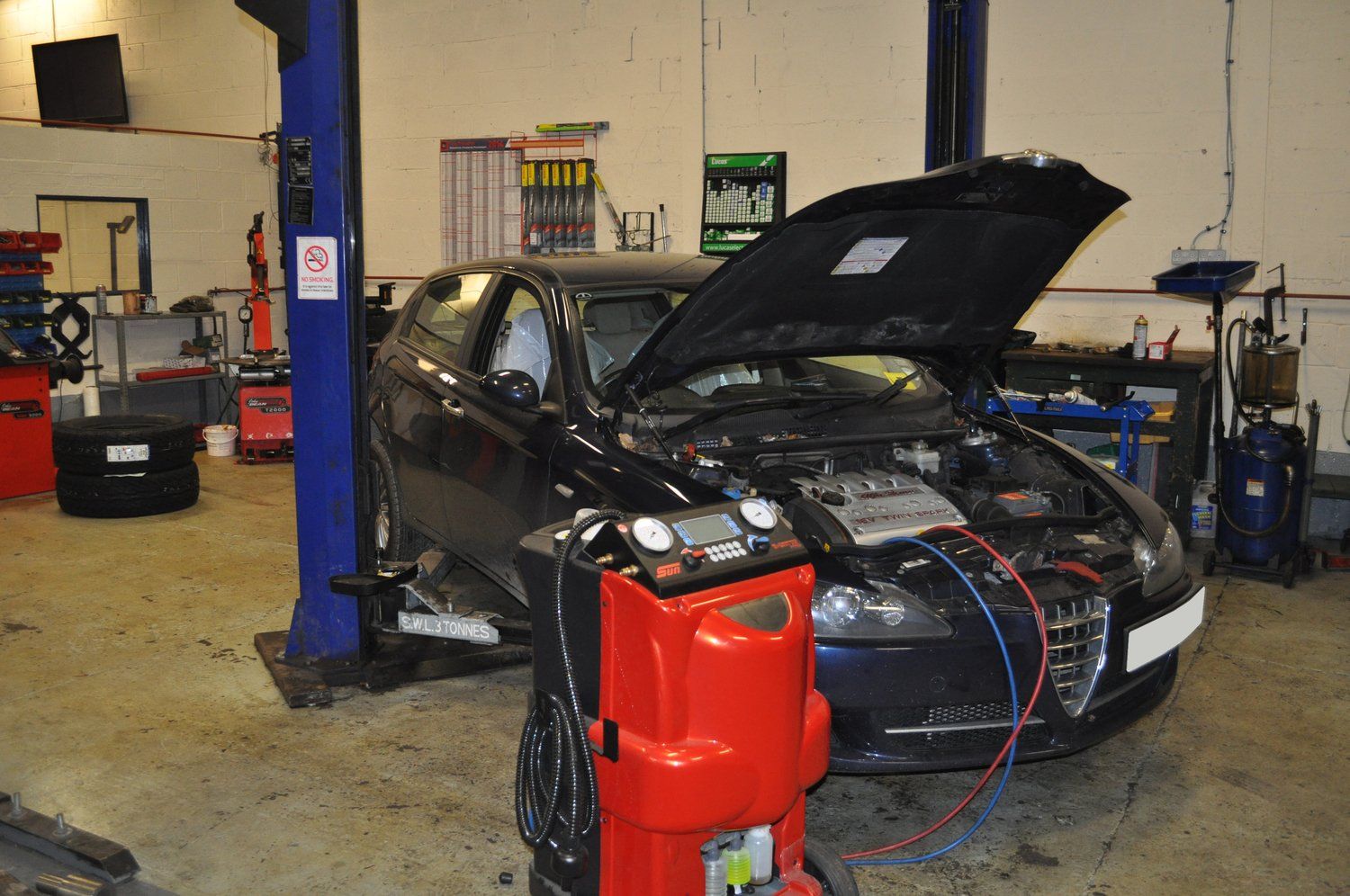Car with bonnet open and engine on display