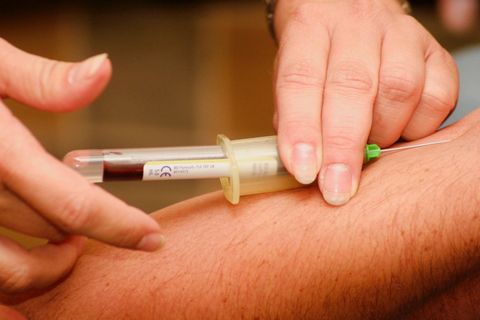 getting blood from man with syringe