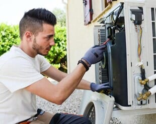 Electrician Installing Air Conditioning Unit — Home Comfort Systems in Bolingbrook, IL Electrician Installing Air Conditioning Unit — Home Comfort Systems in Bolingbrook, IL