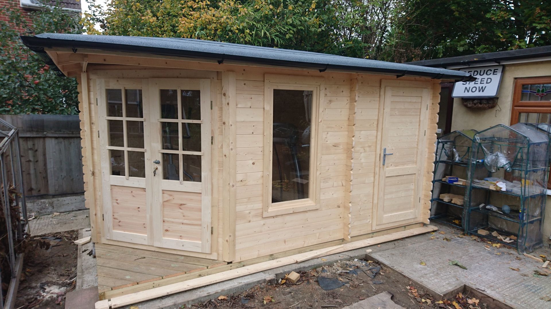 completed log cabin in a garden