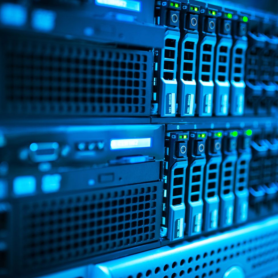 Server rack with rows of data storage units, lit with blue light.