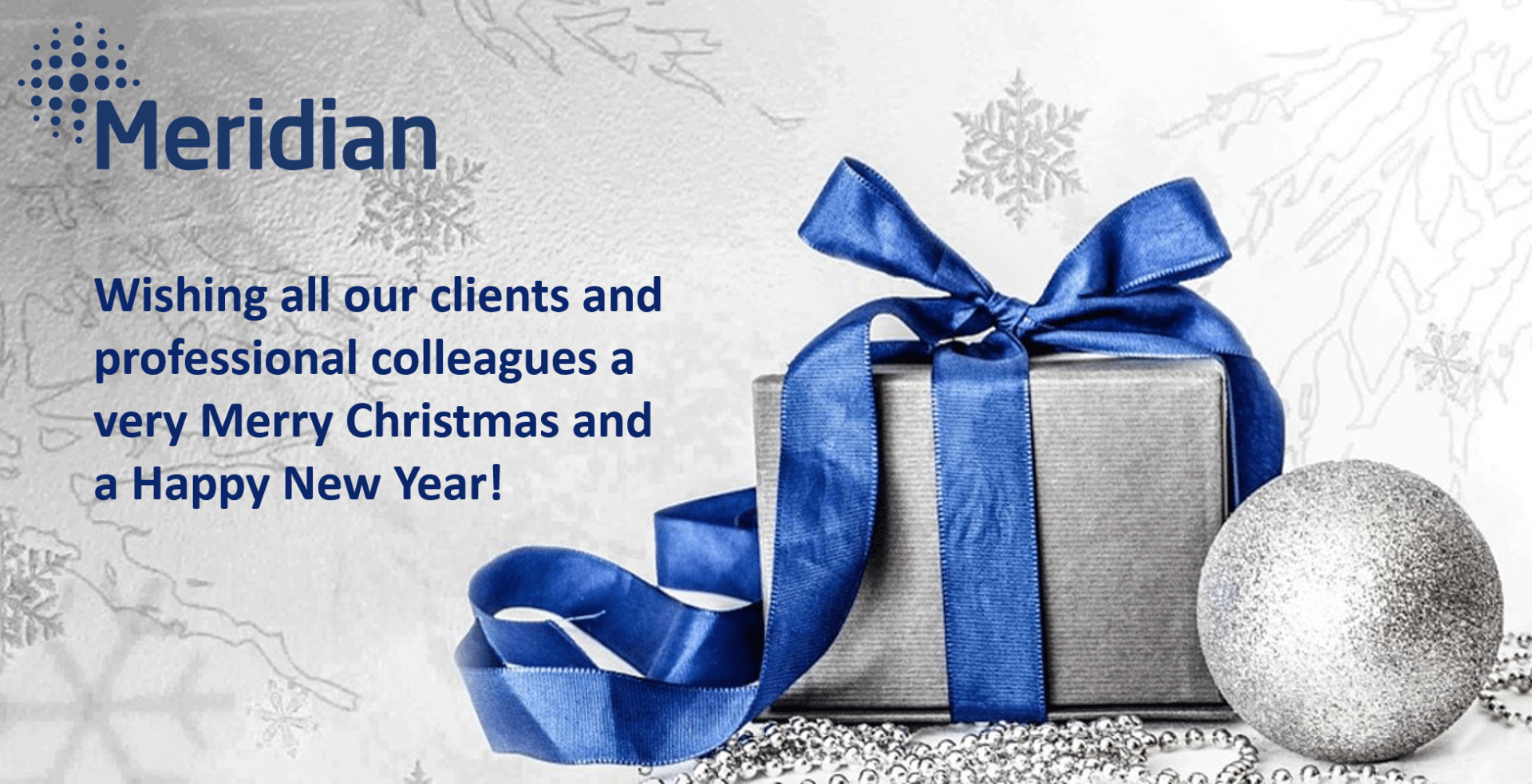 Christmas greeting from Meridian: gift box with blue ribbon and silver ornament, text wishing clients a Merry Christmas and Happy New Year.