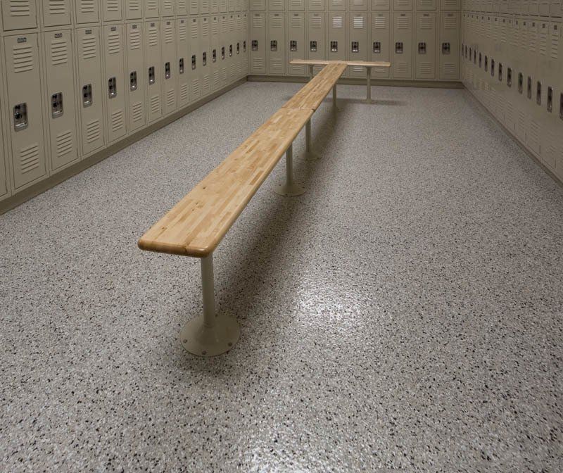 A locker room with lots of lockers and a bench