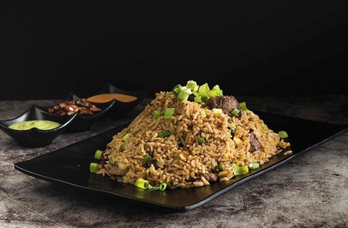 One serving of a fried rice with onion chives toppings — Palm Desert, CA — Mi Cultura