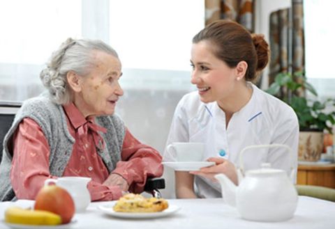 nurse with old lady drinking