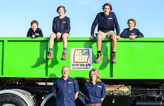 all west family portrait next to truck