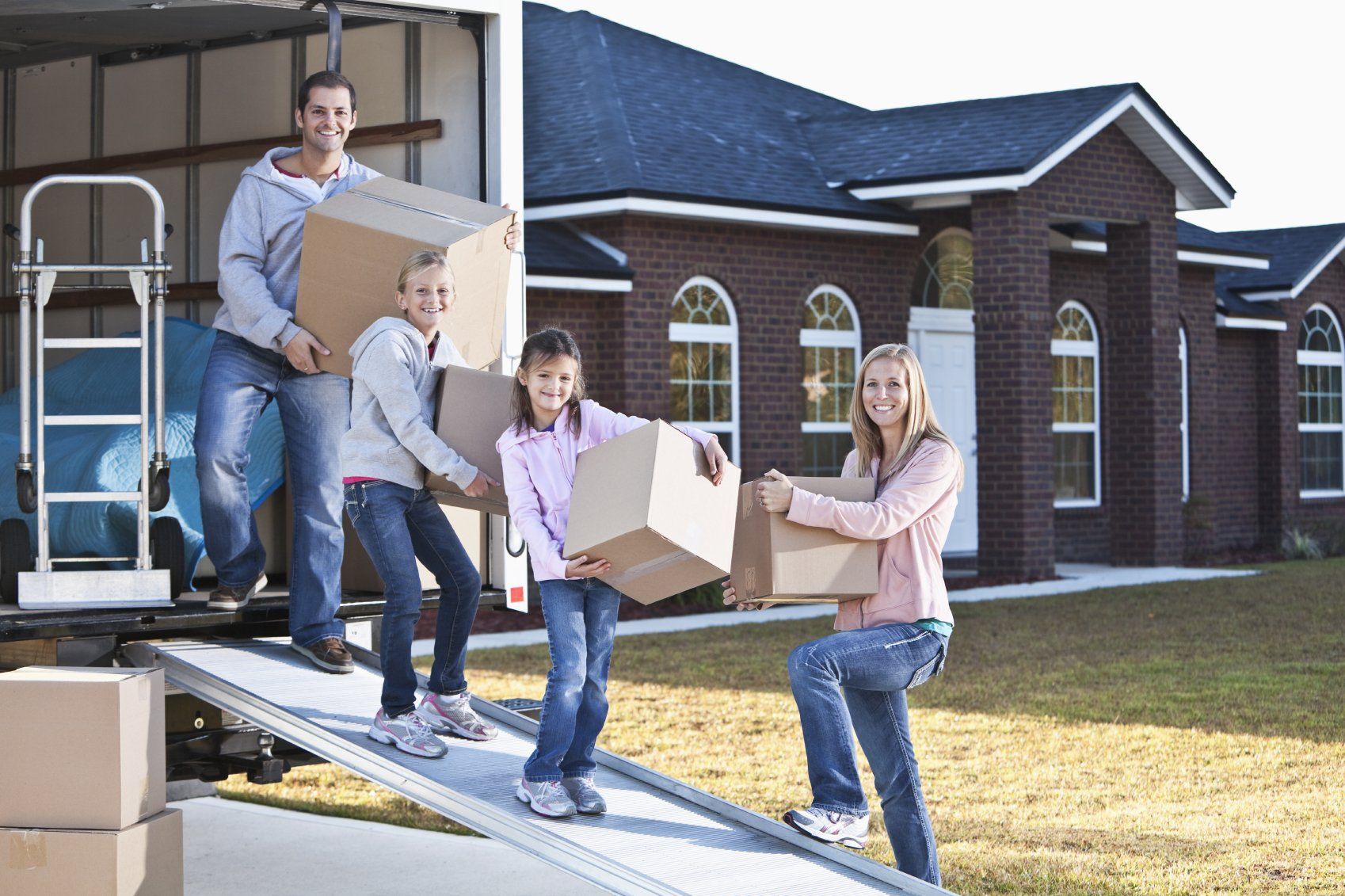 Family moving house, unloading truck