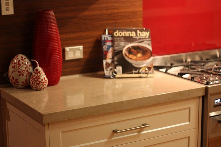 end solid surface counter with white drawers underneath