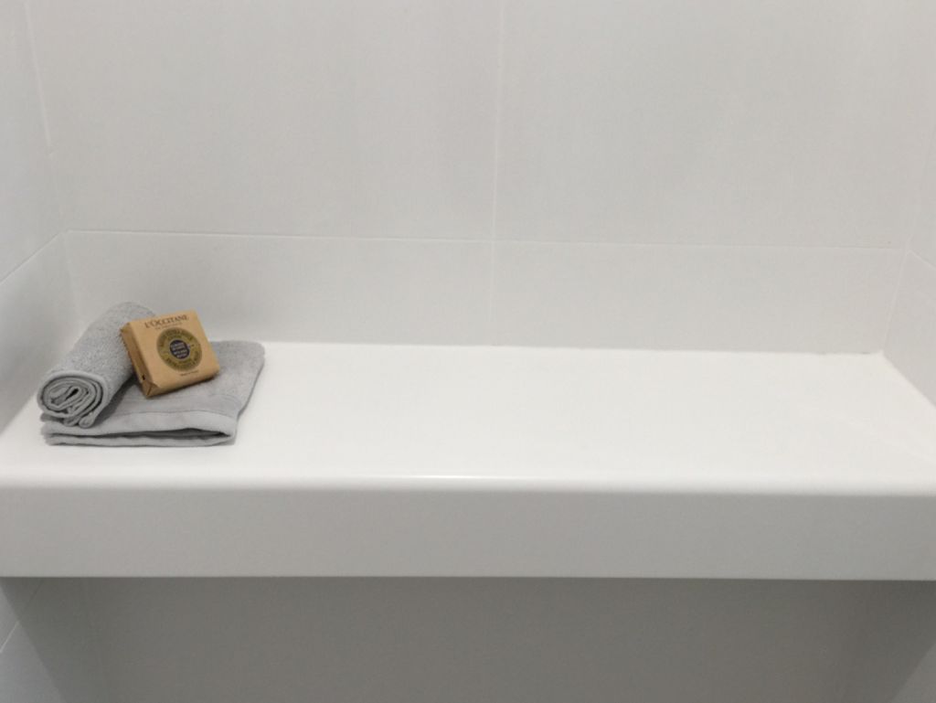 white modern bathroom with solid surface counters