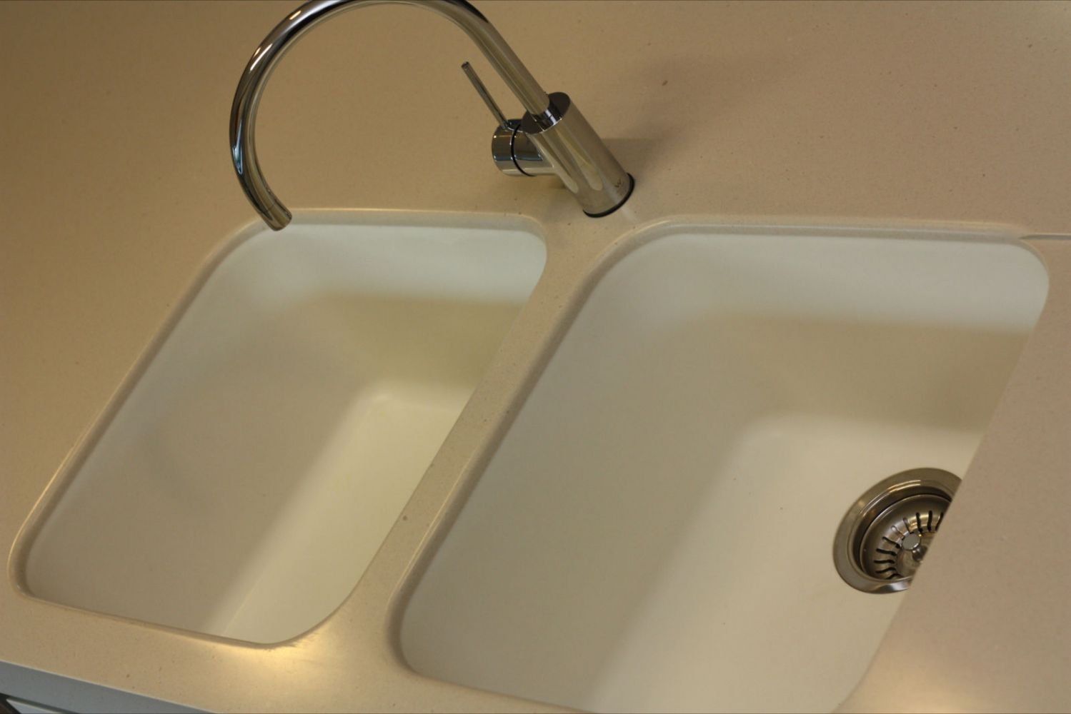 solid surface kitchen sink with stainless steel faucet