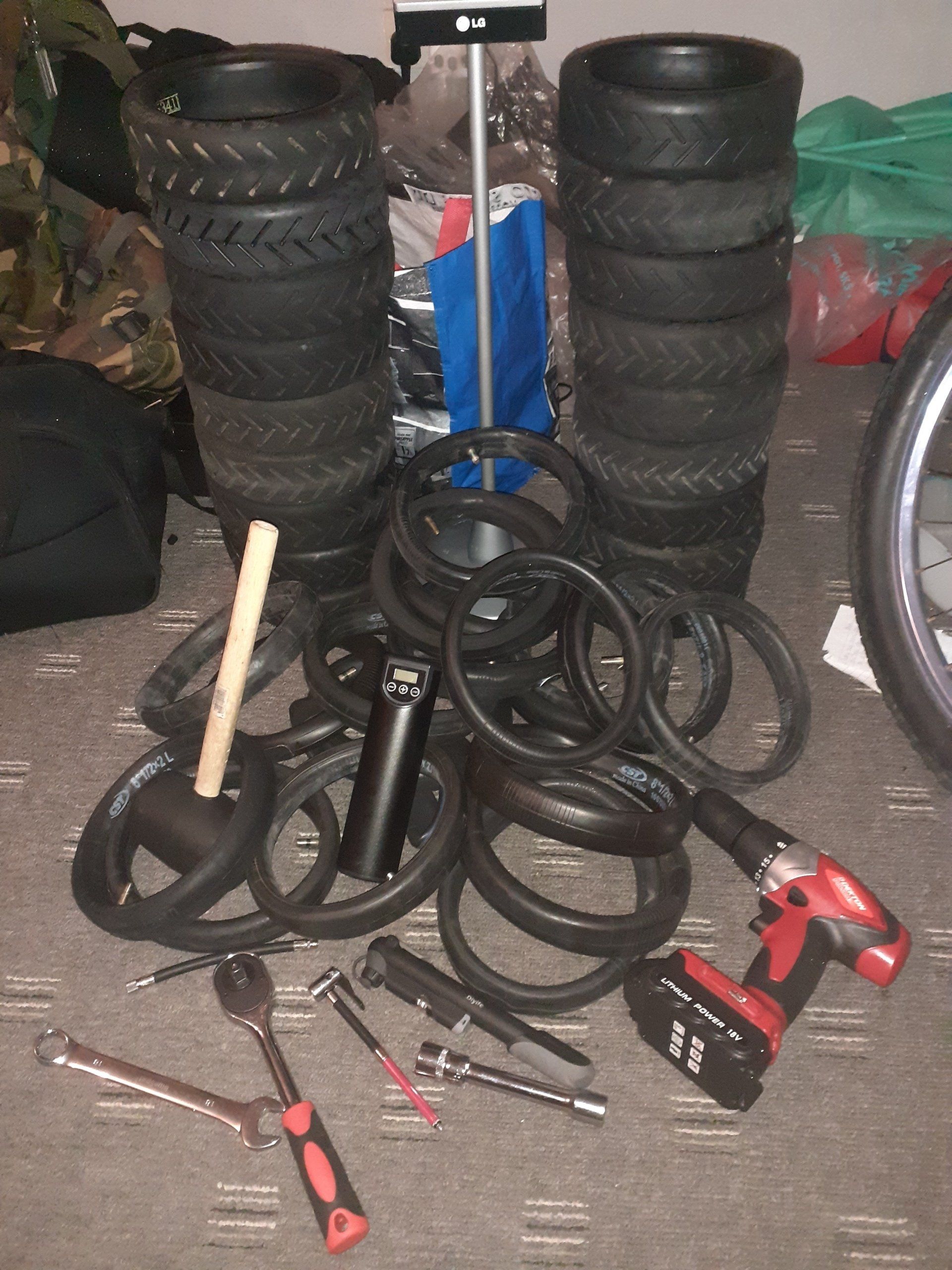 A pile of bike tires and tools on the floor