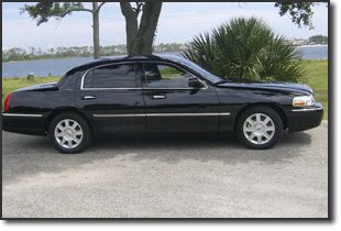 Prestige Limousine — Glossy Black Sedan Side View in Pensacola, FL