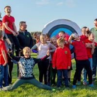 A group of children are posing for a picture in front of a target.
