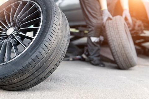 Mechanic doing a tire change — Lawrence, KS — Lighthouse Tow & Recovery Mechanic doing a tire change — Lawrence, KS — Lighthouse Tow & Recovery