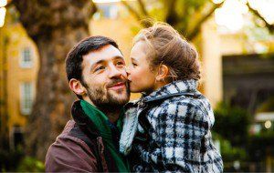 Daughter Kisses Her Father On Cheeks — Peoria, IL — The Insurance Office