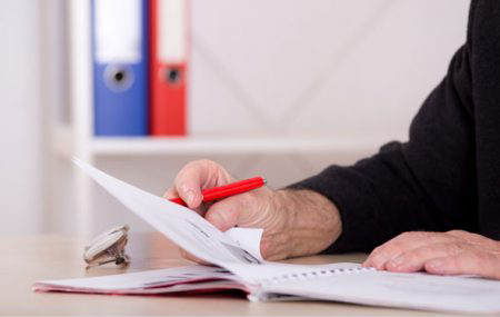 Senior Man Reading Notes — Peoria, IL — The Insurance Office