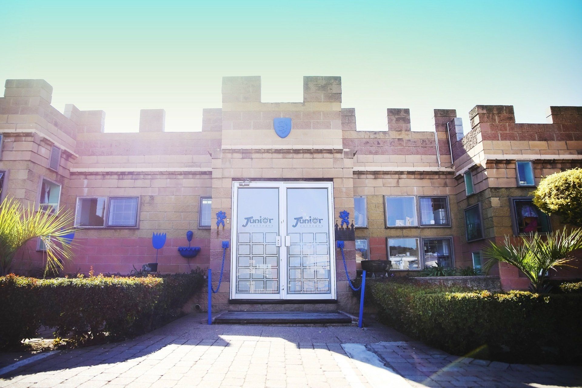 A brick building with a blue shield on the top of it