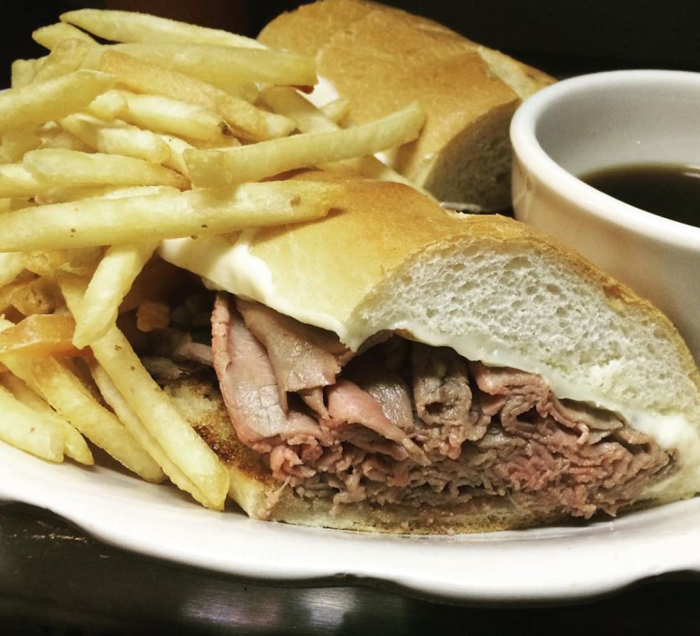 image of a French dip sandwich with fries and au jus