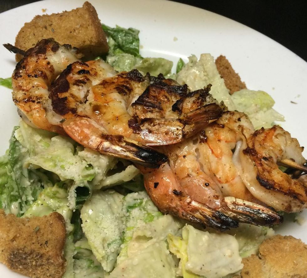 grilled shrimp over lettuce with croutons and dressing