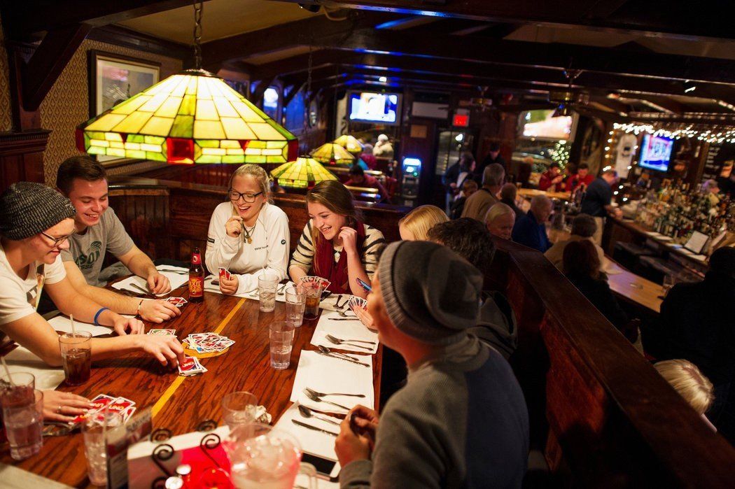 group of guests playing cards at large table